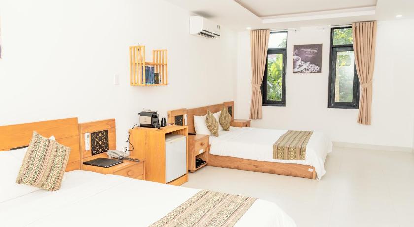 a room with a bed, a desk and a window, Trung Nguyên Coffee Resort in Buon Ma Thuot