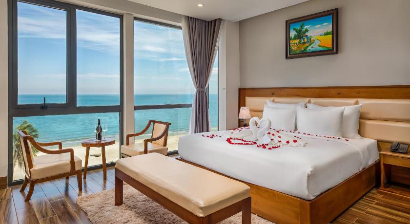 a hotel room with a bed, table and chairs, Alisia Beach Hotel Da Nang in Da Nang