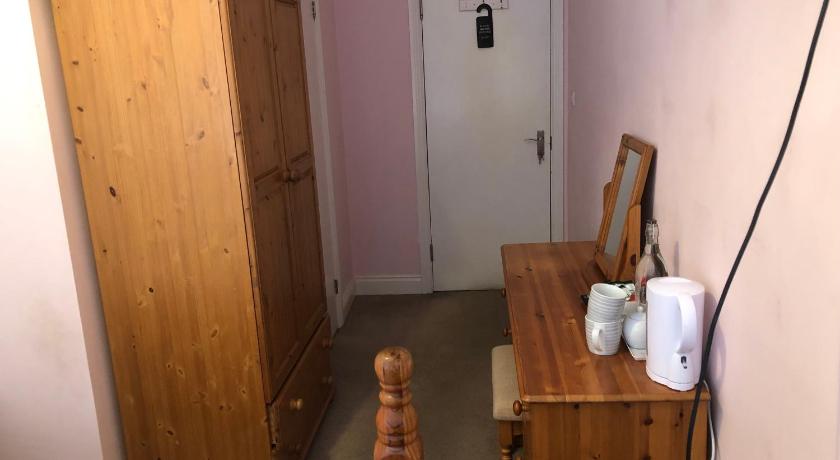 a small room with a wooden floor and wooden furniture, 287 Green Lanes in London