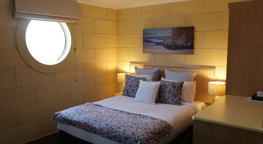 a hotel room with a bed and a mirror, Portside Motel in Great Ocean Road - Port Campbell