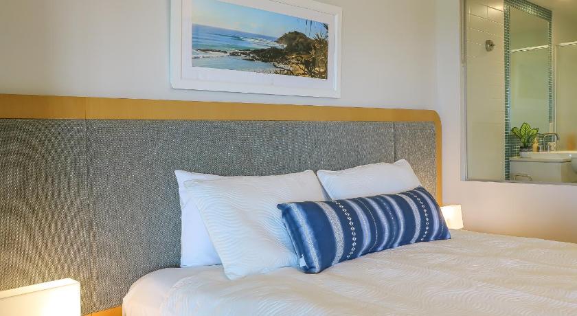 a hotel room with a bed and a mirror, Resort Rooms at Bells Boulevard in Kingscliff