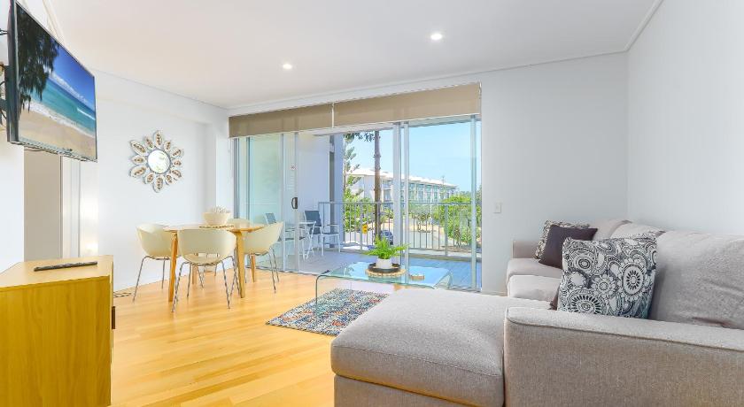 a living room filled with furniture and a window, Resort Rooms at Bells Boulevard in Kingscliff