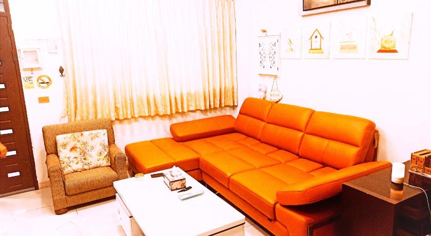 a living room with a couch and a coffee table, Birds Flower B&B in Yilan