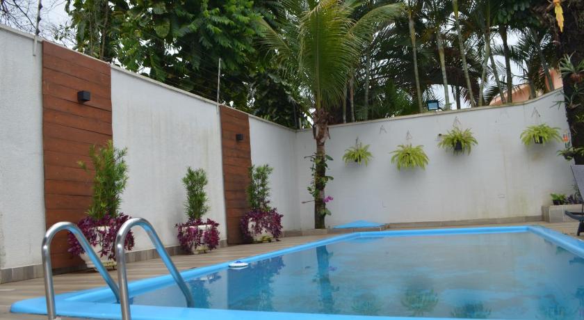 a swimming pool with a pool table and chairs, Foz Casa do Turista in Foz Do Iguacu
