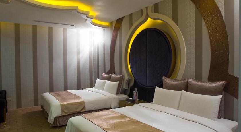 a hotel room with a bed and a night stand, One Plus One Hotel in Taoyuan