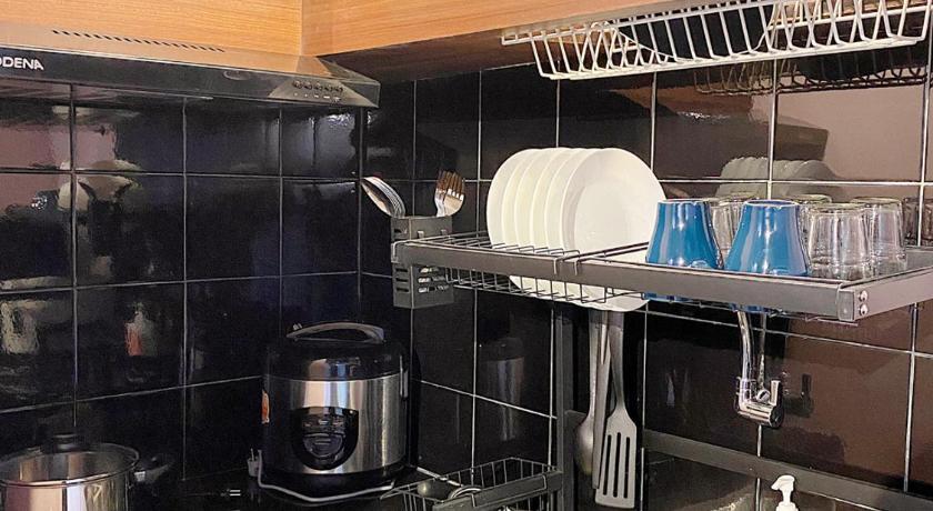 a kitchen with a sink, microwave, and dishwasher, youre at - The Majesty Apartment in Bandung