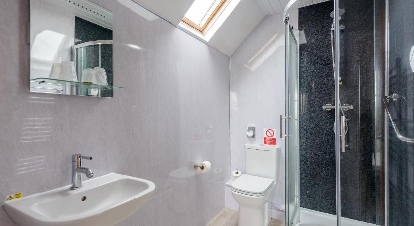 a bathroom with a shower, sink, and toilet, County Hotel in Kendal
