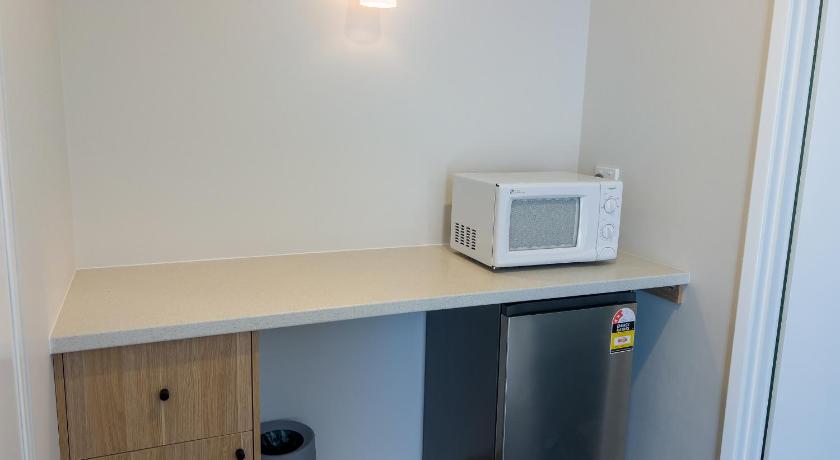 a white microwave sitting on top of a white counter top, A1 Motel Port Fairy in Port Fairy