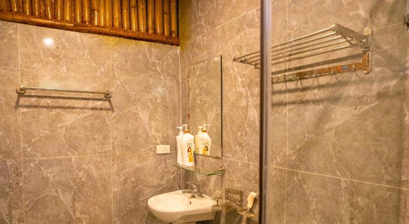 a bathroom with a toilet, sink, and shower stall, Lotus Field Homestay in Ninh Bình