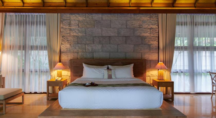 a bed room with a large bed and a large window, Arumdalu Private Resort in Belitung