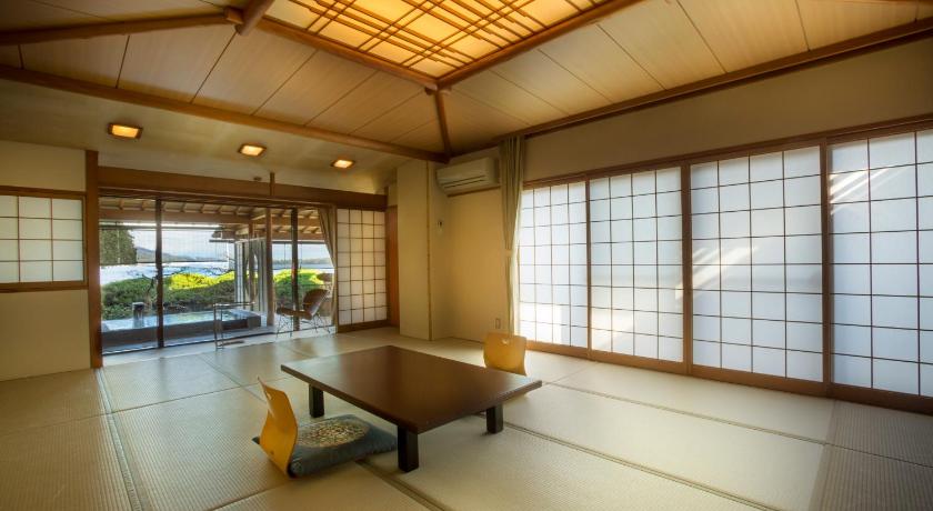 a living room with a large window, Hotel Kitanoya in Miyazu