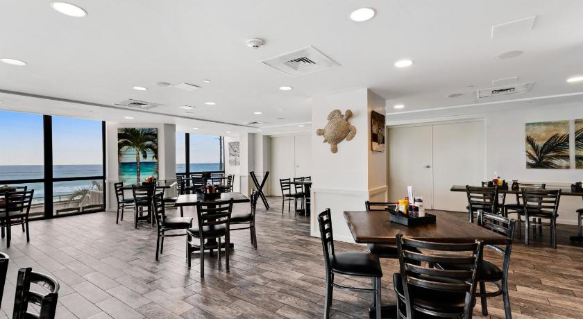 a dining room table with chairs in front of a large building, Surfside Resort 3-1208 in Destin (FL)