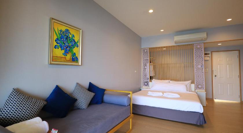a hotel room with a bed and a desk, Raya Buri Resort in Kanchanaburi