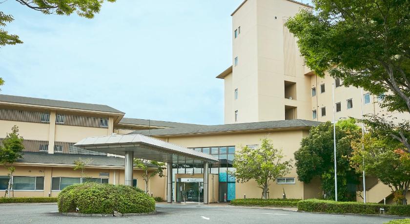 a large building with a tree in front of it, KAMENOI HOTEL HIKONE in Hikone