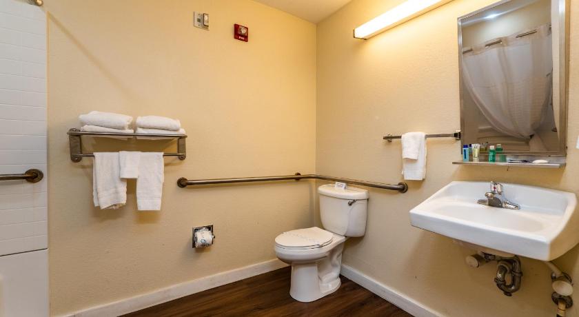 a white toilet sitting next to a white sink, Microtel Inn & Suites by Wyndham Ocala in Ocala (FL)
