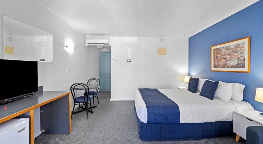 a hotel room with two beds and a television, MAS Country  Riverboat Lodge Motor Inn in Echuca