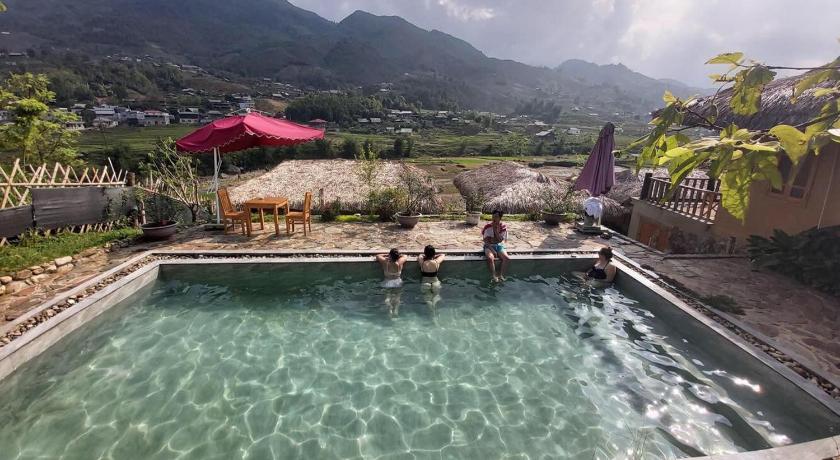two people are relaxing in a pool with a waterfall, Sapa Eco Bungalows & Spa in Sapa