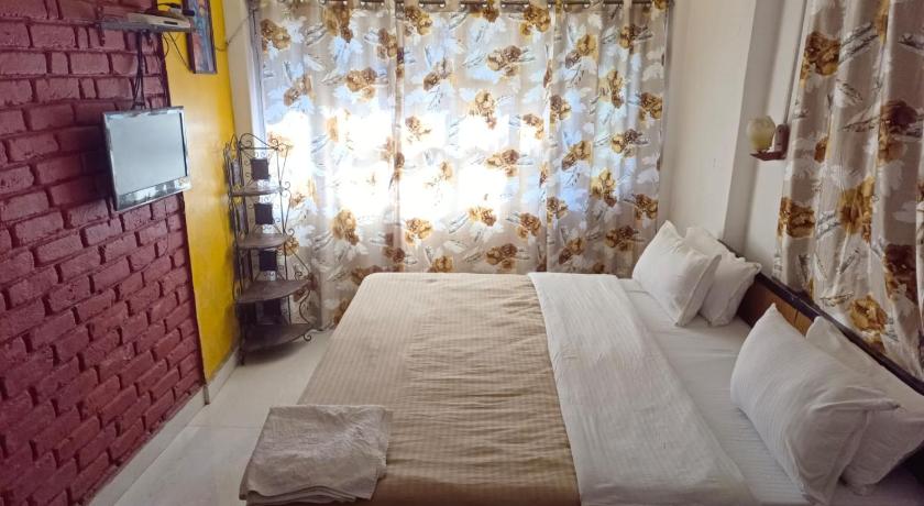 a bed room with a white bedspread and pillows, Mcleodganj Bed And Breakfast in McLeod Ganj