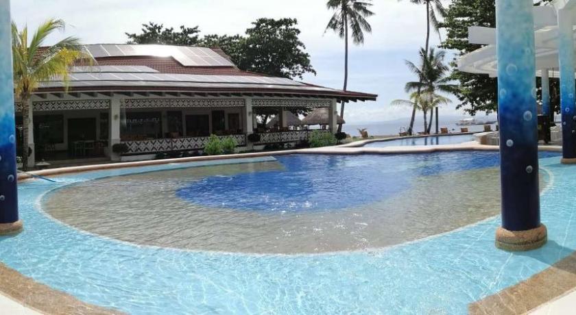 a swimming pool with a pool table and chairs, Pura Vida Beach and Dive Resort Dauin in Dumaguete