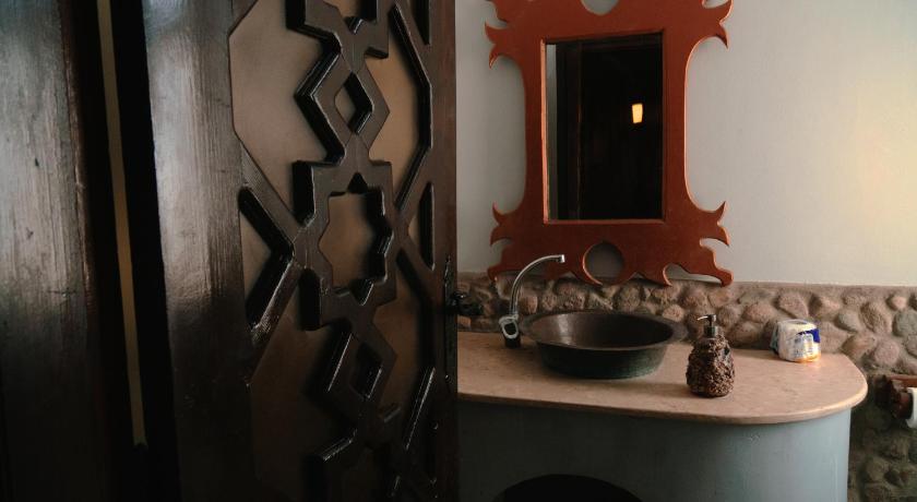 a bathroom with a sink and a mirror, Alf Leila Boutique Hotel in Dahab