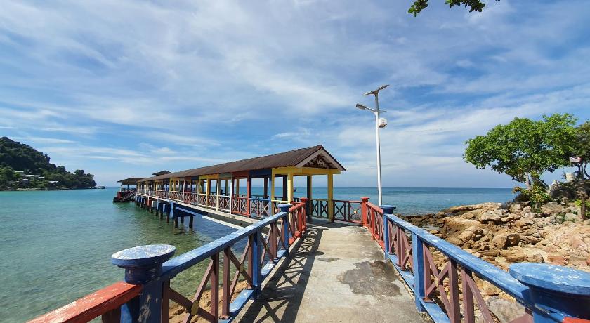 a pier with a train on it next to a body of water, Ombak Dive Resort in Perhentian Islands