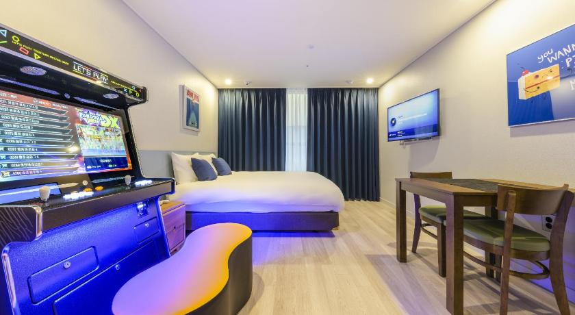 a hotel room with a large screen tv, Ventimo Hotel and Residence Jeju  in Jeju