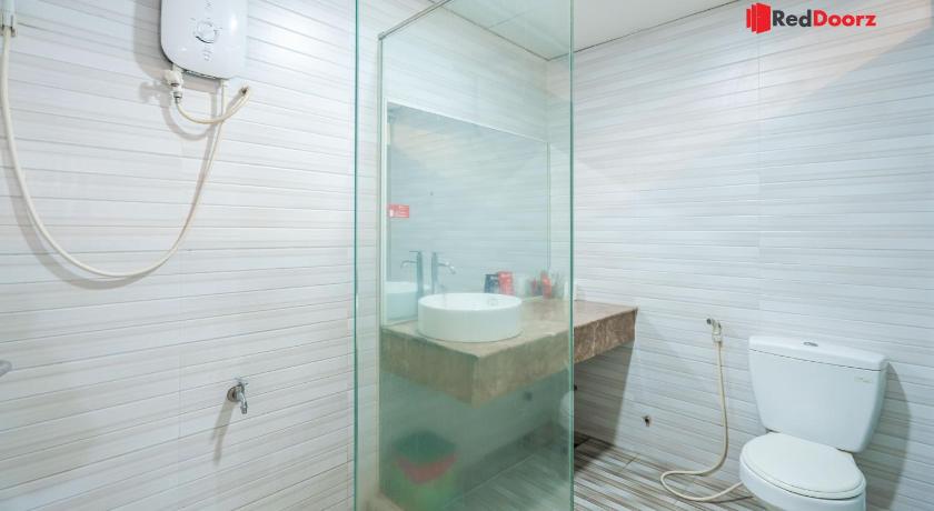 a bathroom with a toilet, sink, and shower, RedDoorz Khoi Nguyen Hotel Ly Chinh Thang in Ho Chi Minh City