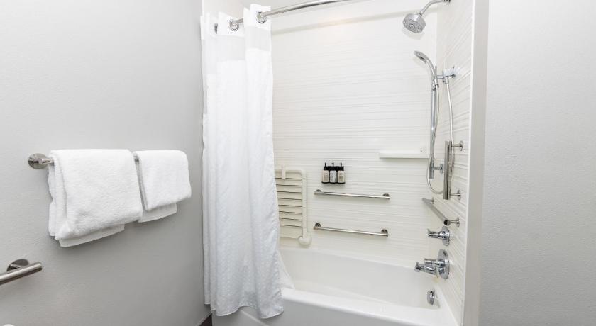 a bathroom with a shower, sink, and toilet, Avid Hotels Denver Airport Area in Denver (CO)