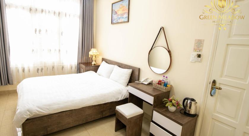 a bedroom with a white bed and white walls, Green Meadow Hotel  Dalat in Dalat