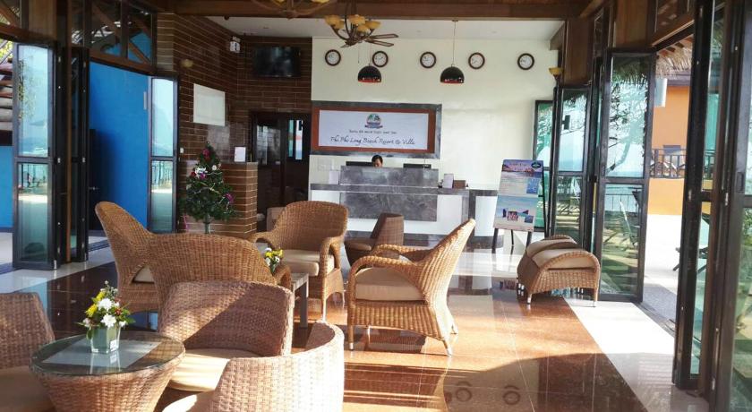a living room filled with furniture and a table, Phi Phi Long Beach Resort and Villa (SHA Plus+) in Ko Phi Phi