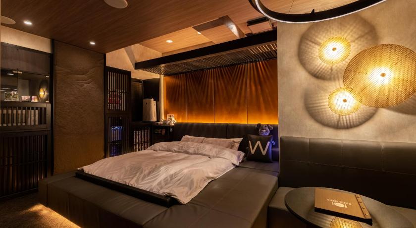 a bedroom with a bed and a nightstand, Design Hotel W Zip Club in Nagoya