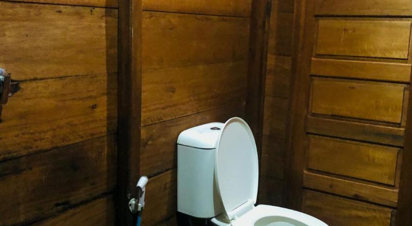 a toilet in a room with a wooden floor, Wonderful Citamiang by Anrha in Puncak