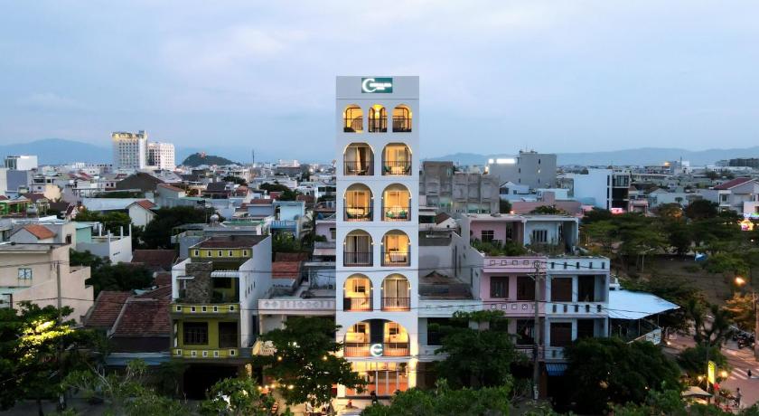 a tall building with a clock on it's side, Coralina Hotel in Tuy Hòa (Phú Yên)