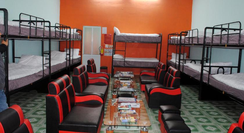 a room filled with lots of beds and chairs, Phong Nha Backpacker Hostel in Đồng Hới (Quảng Bình)