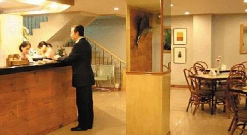 a man standing in front of a counter in a restaurant, Nichols Airport Hotel in Manila