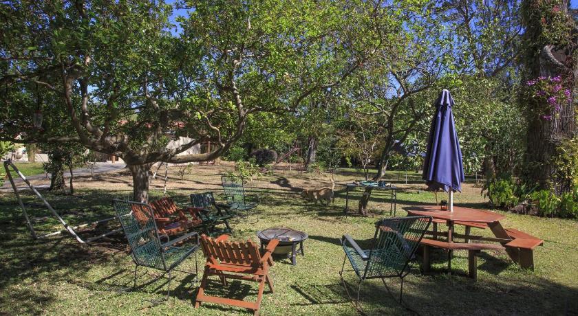a picnic table and chairs in a grassy area, Airport Costa Rica B&B in Alajuela