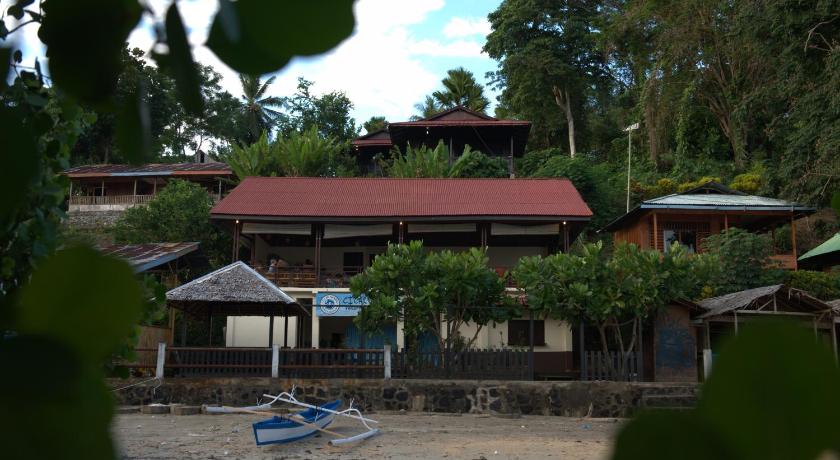 a house with a patio and chairs and trees, Happy Gecko Dive Resort in Manado