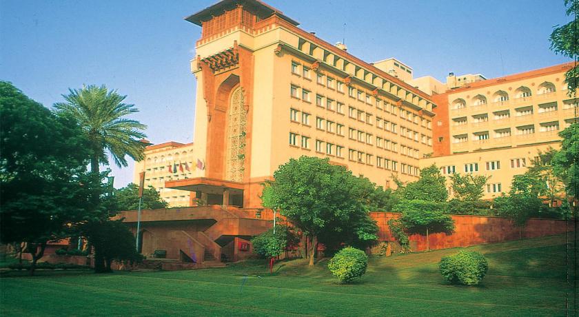 a large building with a clock on the top of it, The Ashok Hotel in New Delhi and NCR