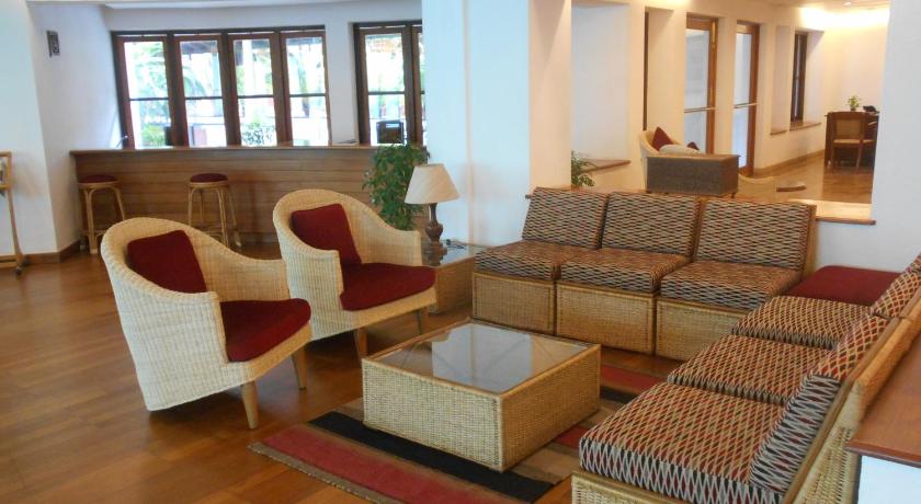a living room filled with furniture and a couch, Casino Hotel in Kochi