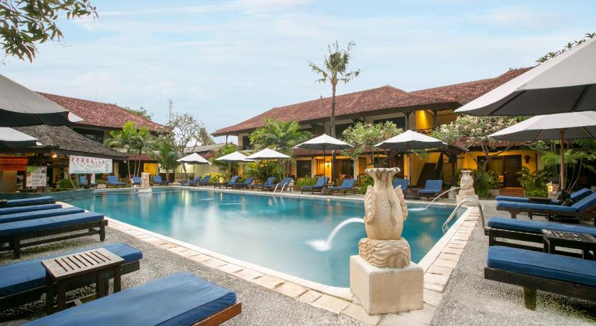 a swimming pool with several tables and chairs, Legian Paradiso Hotel in Bali