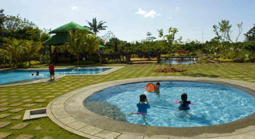 two children playing in a pool with a blue umbrella, Hotel Kimberly Tagaytay in Tagaytay