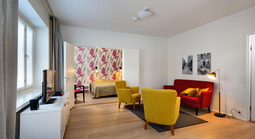 a living room filled with furniture and a window, Forenom Serviced Apartments Helsinki Kruununhaka in Helsinki