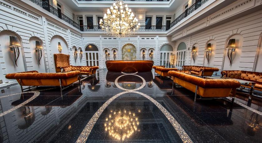 a large lobby filled with lots of tables and chairs, Prestige Hotel Budapest in Budapest