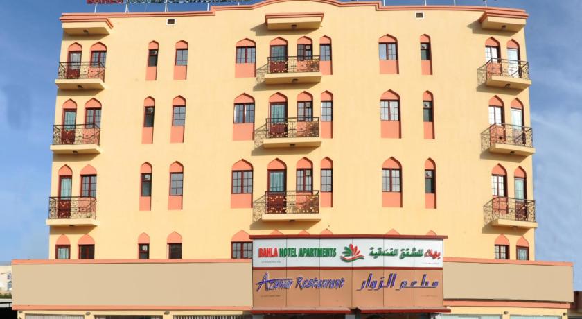 a large building with a sign on the side of it, Bahla Hotel Apartments in Nizwa