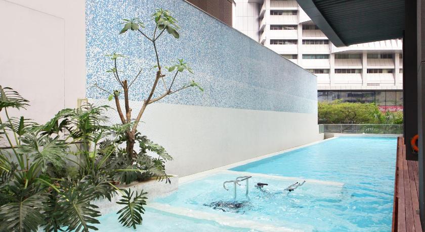a large swimming pool in a large building, Pan Pacific Serviced Suites Orchard in Singapore