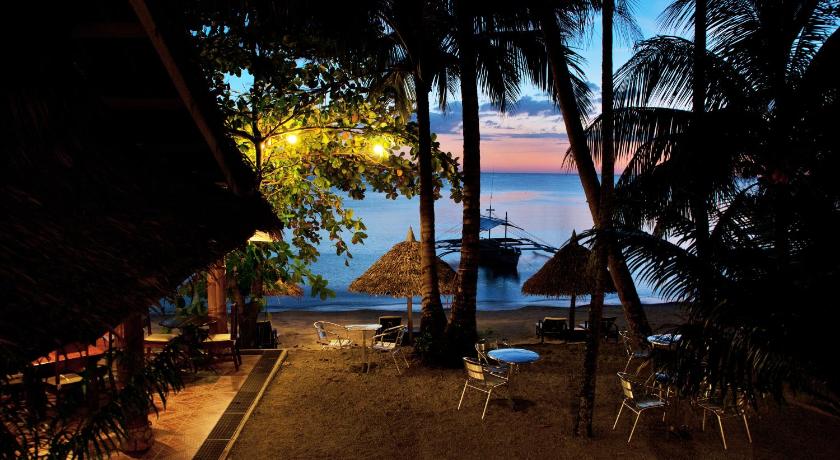 a beach with palm trees and palm trees, Easy Diving and Beach Resort in Sipalay
