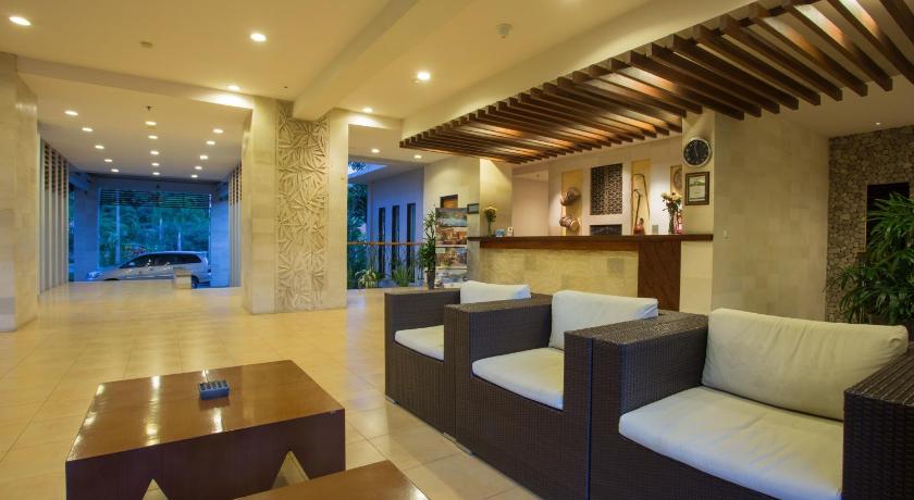 a living room filled with furniture and a large window, Bintang Flores Hotel in Labuan Bajo