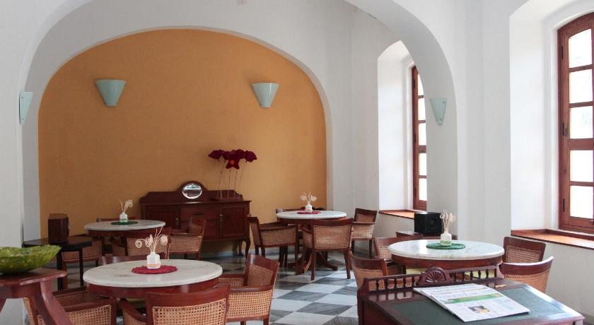 a dining room filled with tables and chairs, Palais De Mahe - CGH Earth in Pondicherry