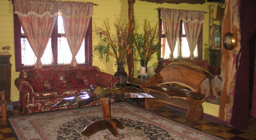 a living room filled with furniture and decorations, Casa Antigua Hotel in Alajuela