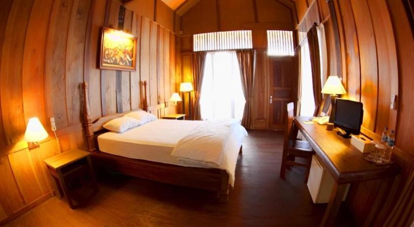 a hotel room with a bed and a desk, Wakatobi Patuno diving and Beach Resort by SAHID in Wangiwangi Island